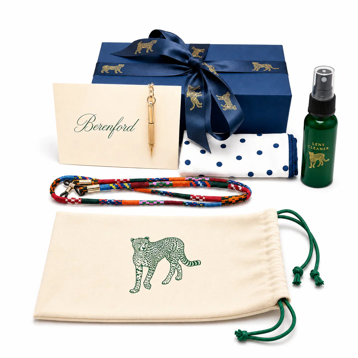 Berenford packaging set: navy box with leopard ribbon, cream pouch with green leopard, polka-dot cleaning cloth, beaded strap, brass pen and lens cleaner